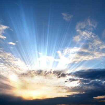 Dark clouds with sun rays over sea.